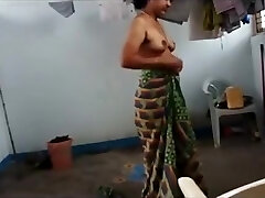 Indian wifey with saggy tits puts on her clothes