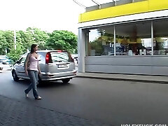 In a public douche she deep throats a cock through a gloryhole