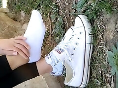 Chinese girl sprains foot in white ankle socks and ebony stretch pants Chinese girl sprains foot in white ankle socks and ebony stretch pants