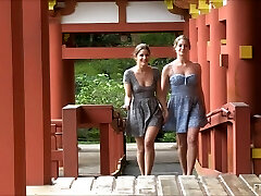 Lesbian couple kissing and flashing at a Japanese temple