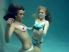 2 girls breath holding and posing underwater