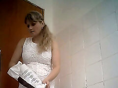 Fine curvaceous ash-blonde lady in white dress filmed in the toilet room