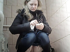 Sweet pale skin blonde teenie in blue jeans urinates in the toilet