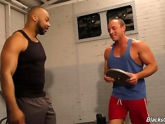 Muscular black top in the gym porks a white bottom