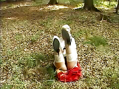 Slim German babe fingering her moist twat in the woods