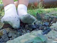 Cute feet in nylon knee socks and white socks teasing you closeup outdoor