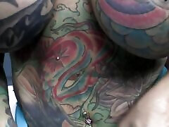Busty tattooed slut gets fucked on the pool table by a only boob far black cock