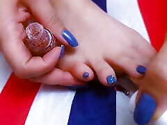 Teen with beautiful nails and legs is painting her nails while masturbate