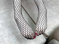 Mistress in black fishnet stockings caresses her legs with pedicure Mistress in black fishnet stockings caresses her legs with pedicure