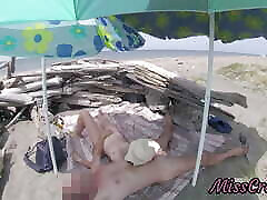 On a nudist beach in Tenerife, the stepdaughter jerks tubey dr her stepfather&039;s cock without shame