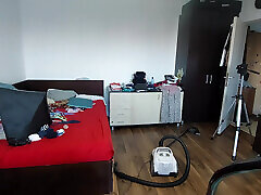 Sexy wife cleans with the vacuum cleaner in the bedroom. Sexy wife epilates the hair on her legs