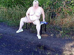 a neighbor in the park undresses and masturbates to orgasm on a bench