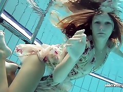 Redhead doll Lucy Gurchenko swimming in a pool