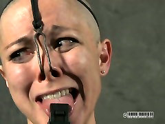 Skinny bald cutie gets her nose holes stuffed with metal hook
