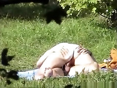 Voyeur tapes a ponytailed brunette girl riding her bf in a field.
