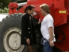 Elegant german girl takes a ride on the bulldozer