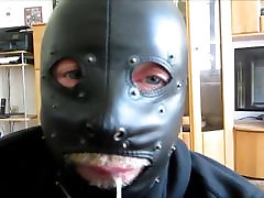 Slave gives kitty vilakku in leather mask