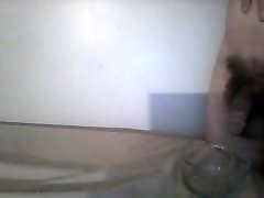 Small dick filling glass bowl with pee