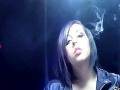 Elegant Brunette Smoking with a Cigarette Holder