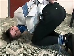 BG Young businessman bound gagged and struggling.