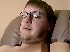 Cute amateur Jack with glasses masturbates on a leather sofa