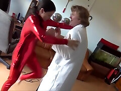 Woman in red latex stethed by pervert doctor