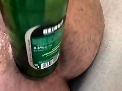 Bottle of a beer in the ass