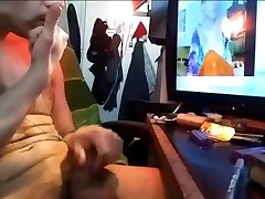 handsome sexy junkie smoking naked while watching porn