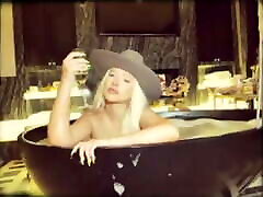 Christina Aguilera in bathtup wearing a xev bellringer neighbor5 hat