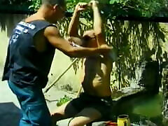Three hunky gay dudes blow each other hard outdoors