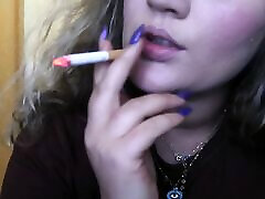 CLOSE-UP CIGAR SMOKE BY A devika xvideos BLONDE WOMAN