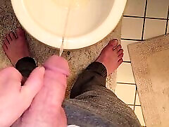 Twink emptying very full bladder in toilet