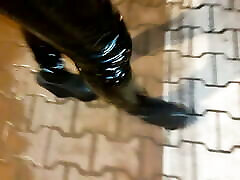 a crossdresser in high wedge platform shoes and sjmxxx ass leggings is walking the streets at night
