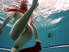 Hot Russian redhead Vesta enjoys swimming around the orgy belgium tube naked
