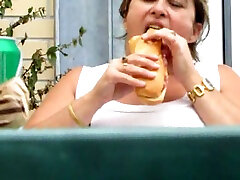 My fat BBW wife eats hotdog and masturbates sitting on the chair