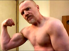 Muscular Daddy bodybuilder flexing muscles in gym vest then strips naked and jerks off his big cock!