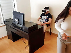Super-steamy stepmother masturbates next to her stepson while he watches porn with virtual reality glasses