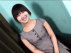Enticing Asian shemale with a cute smile sensually spurts he