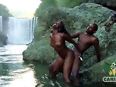 caribbeanflaver.com  island model tearing up at a water fall outdoors 