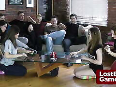 A group of girls are playing a strip game in the living room