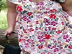 Pussy shown and masturbates under the dress in the park