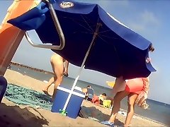 Ravishing woman strips out of a tight red dress in the sun