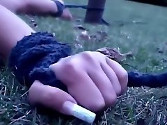 Outdoor prelude of a bondage treatment for a brunette slave