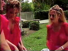Lesbian babes shove huge toys in their holes outdoors