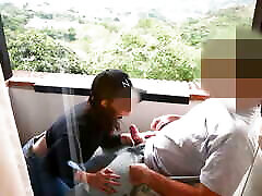 "Branquinha de Leite" gives blowjob to japans sloping saxy beauty w8fe on the balcony of the apartment.
