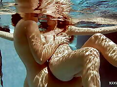 In the indoor pool, two erotic steer life girls swim